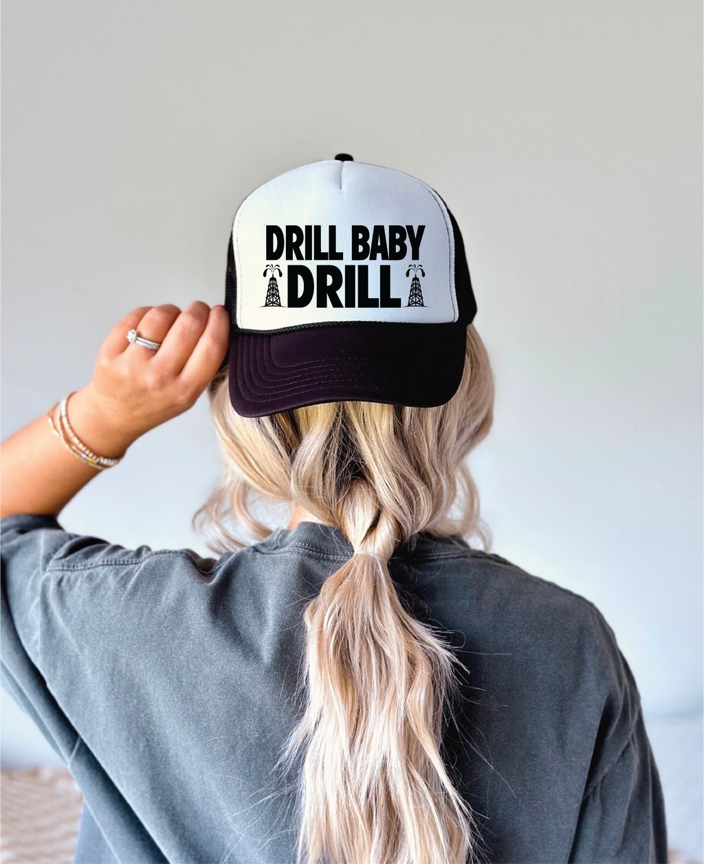 Drill Baby Drill DTF on a Black and white foam trucker hat